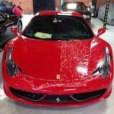 A red ferrari sports car is parked in a garage.