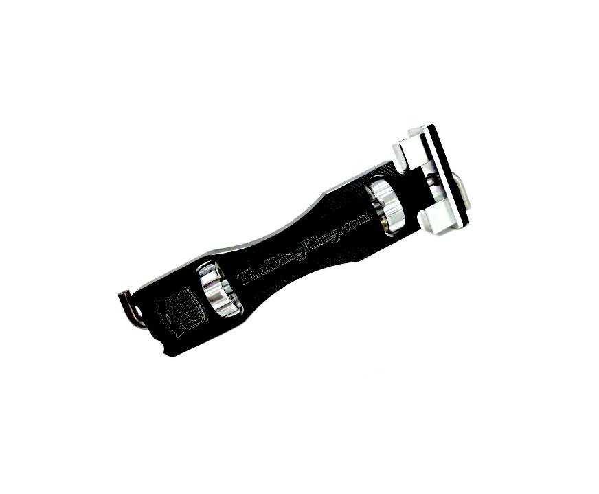 A black razor blade used for paintless dent repair on a white background.