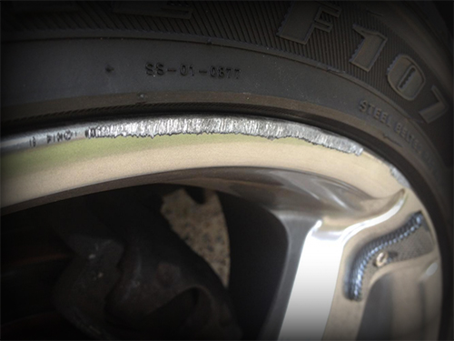 A close up of a tire with a metal rim.